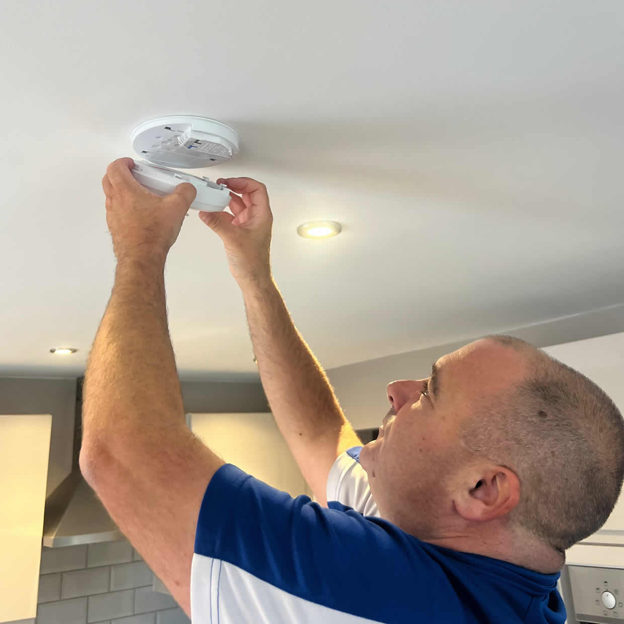 Smoke alarm being installed on a ceiling in Shipley